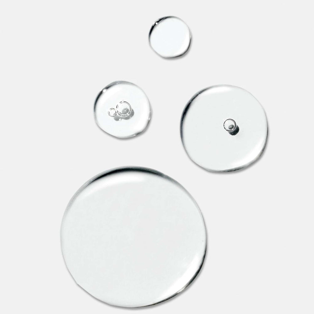 Set of four round circular hydration serum droplets on a white background