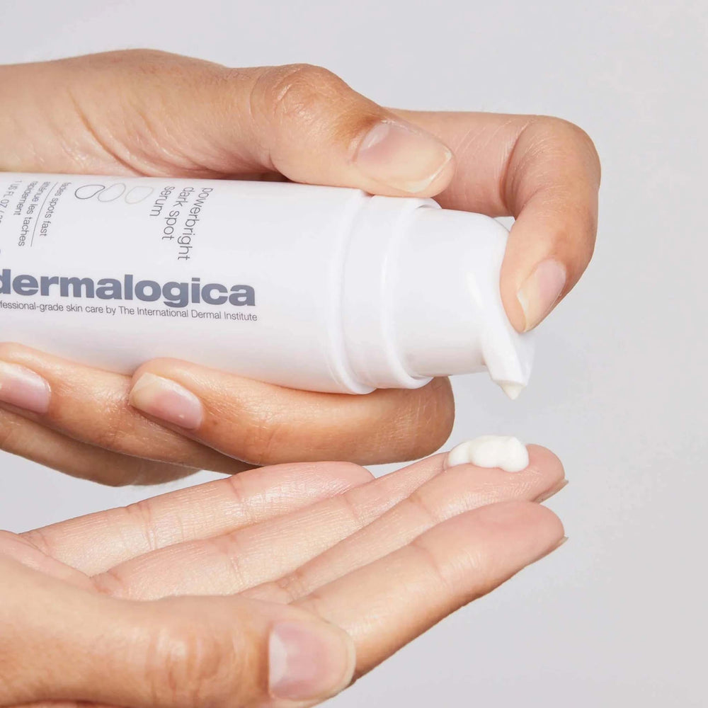 Dermalogica powerbright dark spot serum being applied to a hand with a neutral background